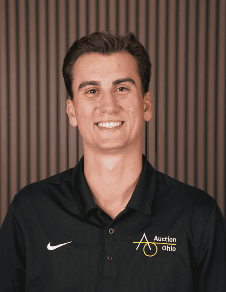 Smiling person in Auction Ohio shirt