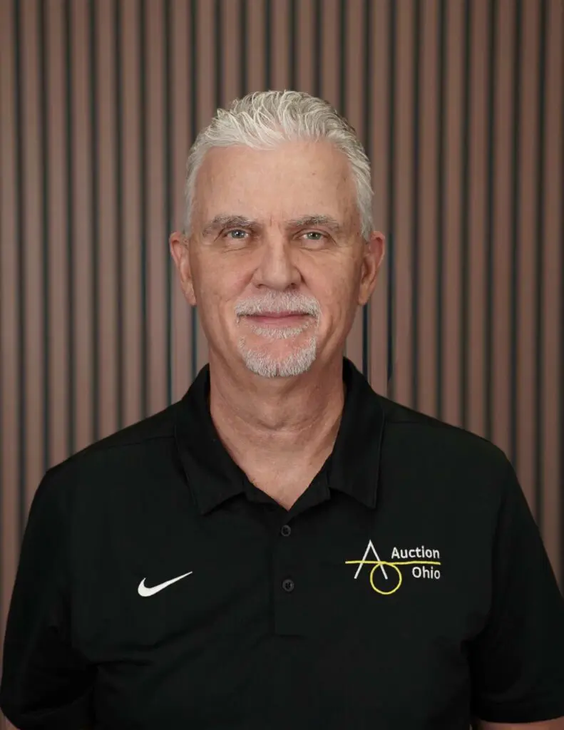 Man in Auction Ohio shirt, stripes background