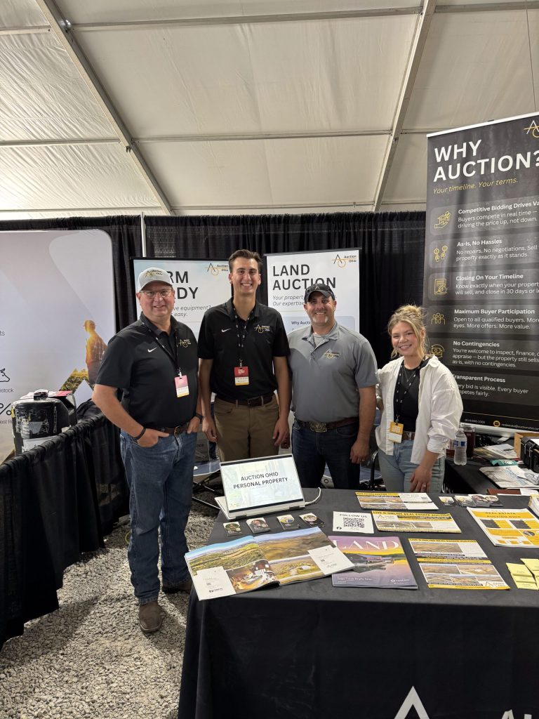 Team staff at a farm auction booth.