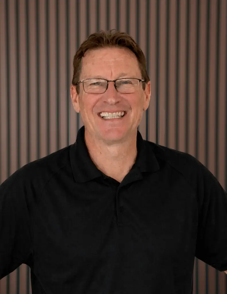 Smiling man wearing glasses and black shirt