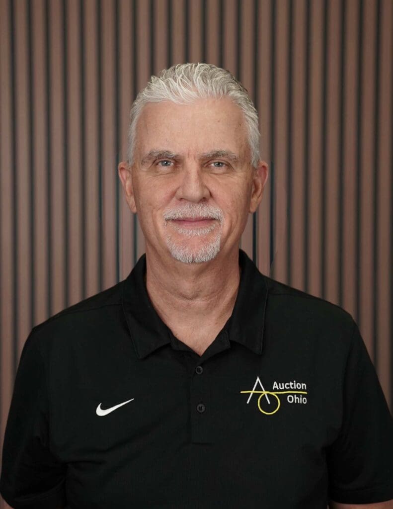 Man in Auction Ohio shirt, stripes background