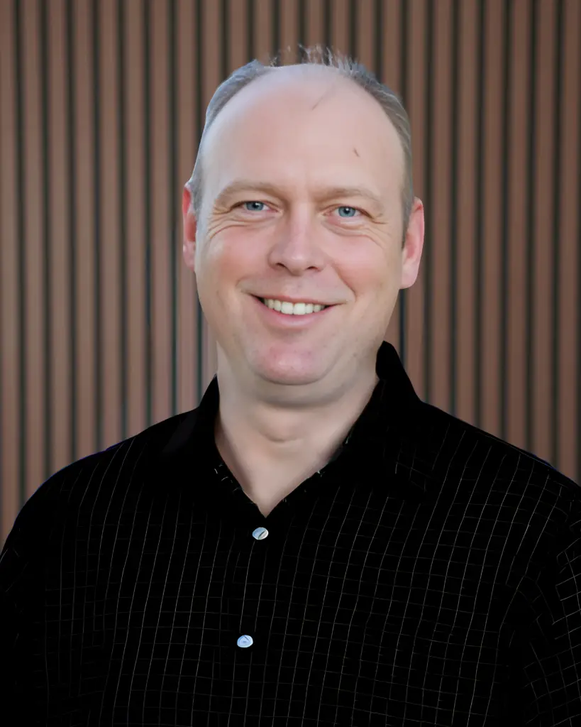 Smiling man in black checkered shirt