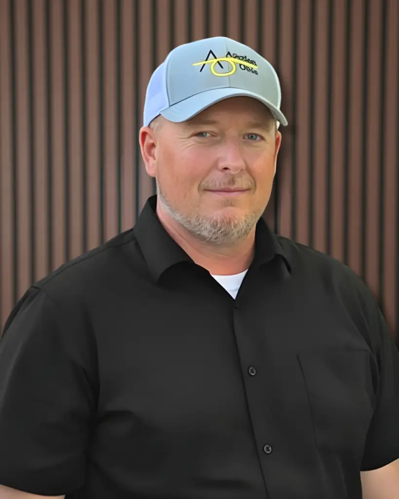 Man wearing blue baseball cap and black shirt