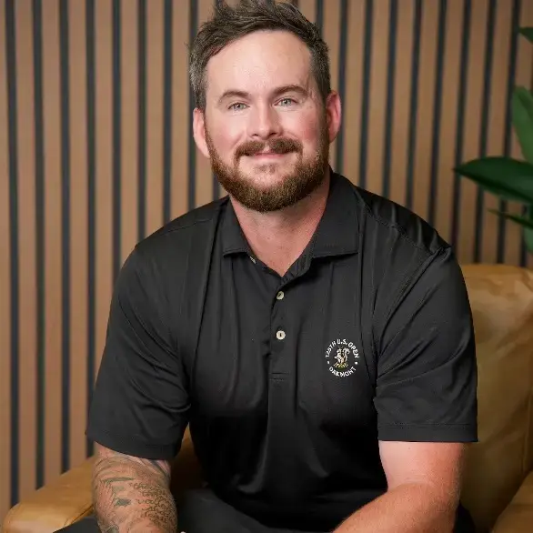 Smiling bearded man in black polo shirt